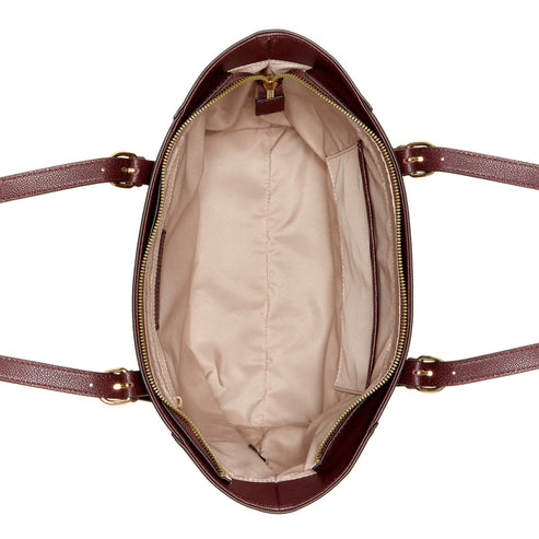 Interior of a maroon tote bag with gold zippers and light colored interior lining.