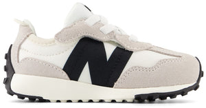 A low top white and gray sneaker with a black N on the side and black sole.