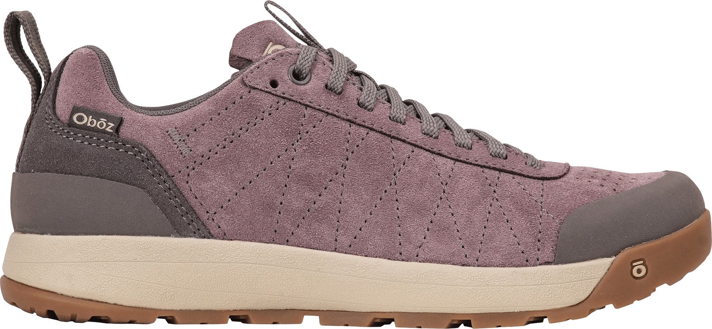 A low-top, mauve-colored suede hiking shoe with a beige midsole, brown rubber outsole, and a heel pull tab, featuring a subtle geometric stitch pattern on the side and the Oboz logo on the heel collar.