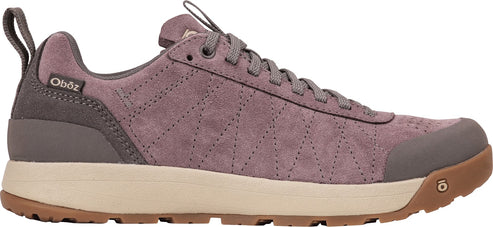 A low-top, mauve-colored suede hiking shoe with a beige midsole, brown rubber outsole, and a heel pull tab, featuring a subtle geometric stitch pattern on the side and the Oboz logo on the heel collar.