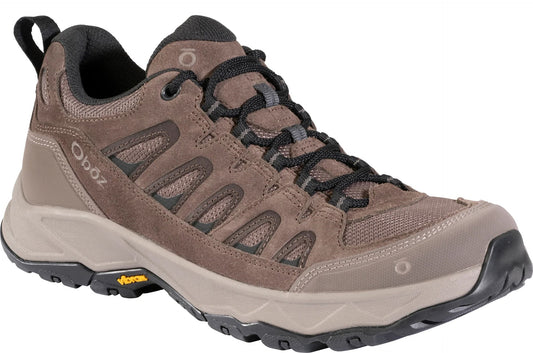 A brown suede and mesh outdoor hiking shoe with a black Vibram rubber outsole, black laces, and the Oboz logo visible on the side and tongue.