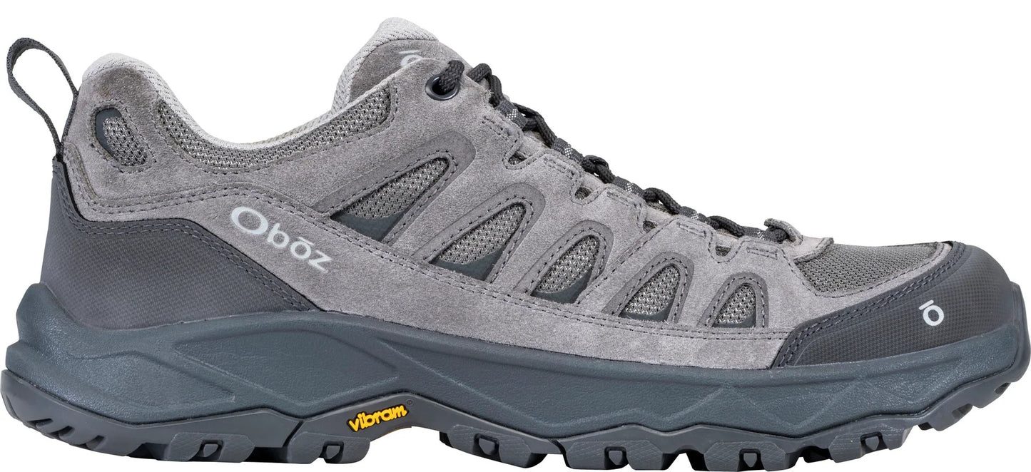 A gray low-top Oboz hiking shoe with a suede and mesh upper, a dark gray midsole, a thick lugged Vibram outsole, and an Oboz logo on the side.