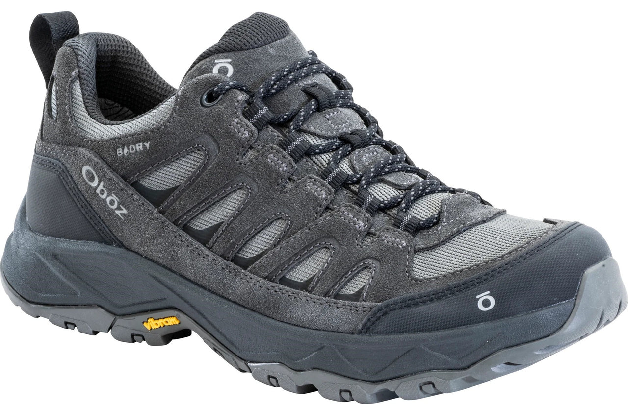 A gray low-top hiking shoe with black accents, laces, a Vibram sole, and the text Oboz and B-DRY visible on the side.