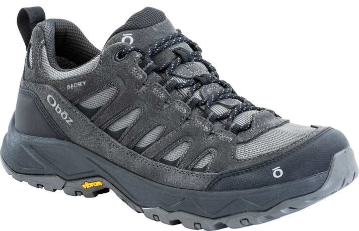 A gray low-top hiking shoe with black accents, laces, a Vibram sole, and the text Oboz and B-DRY visible on the side.