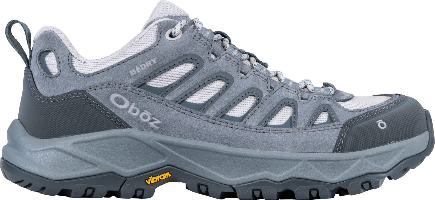 A gray and light gray Oboz B-DRY hiking shoe with a rugged Vibram sole, mesh panels, and a pull loop at the heel, viewed from the side.