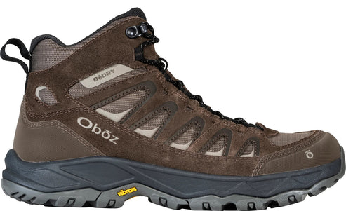 A brown, mid-height waterproof hiking boot with the brand name Oboz, B-DRY technology, and a Vibram sole visible on the side.