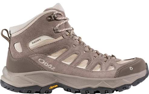 A light brown suede and mesh waterproof hiking boot with a lace-up closure, a cushioned collar, 'B-DRY' branding on the side, and a thick, lugged Vibram rubber sole.