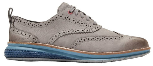 A gray oxford shoe with a blue sole.