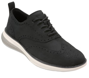 A black, lace-up shoe with brogue detailing and a thick, white sole.