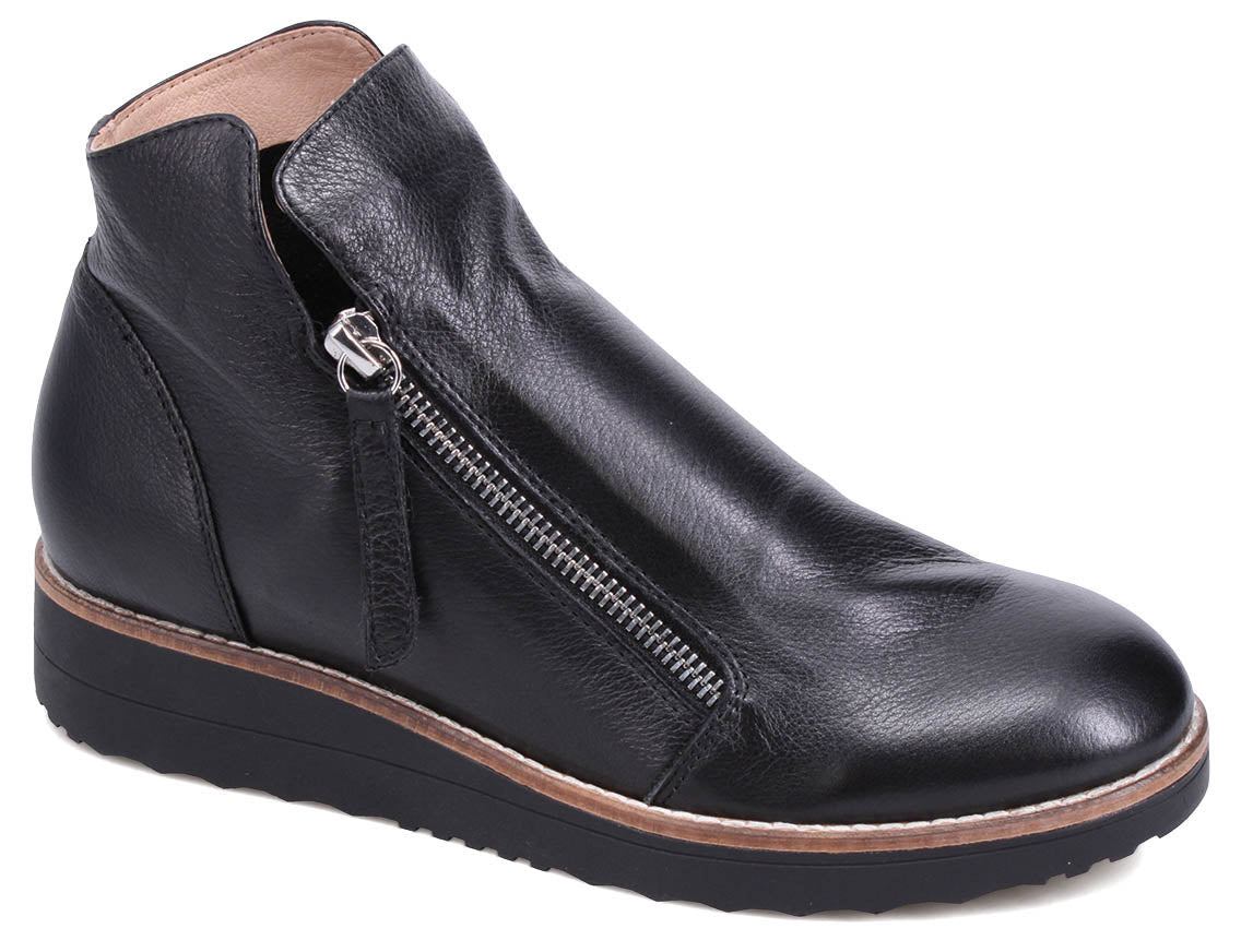 Black leather ankle boot with a side zipper and a low wedge heel.