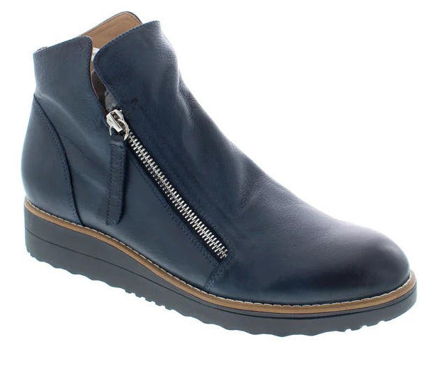 Blue leather ankle boot with side zipper and wedge sole.