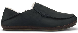 A black slip-on shoe with brown sole and white fur lining.