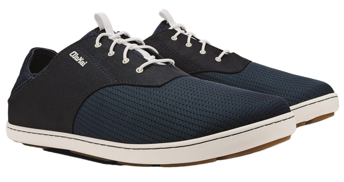 Pair of OluKai men's navy sneakers with white laces and white soles.