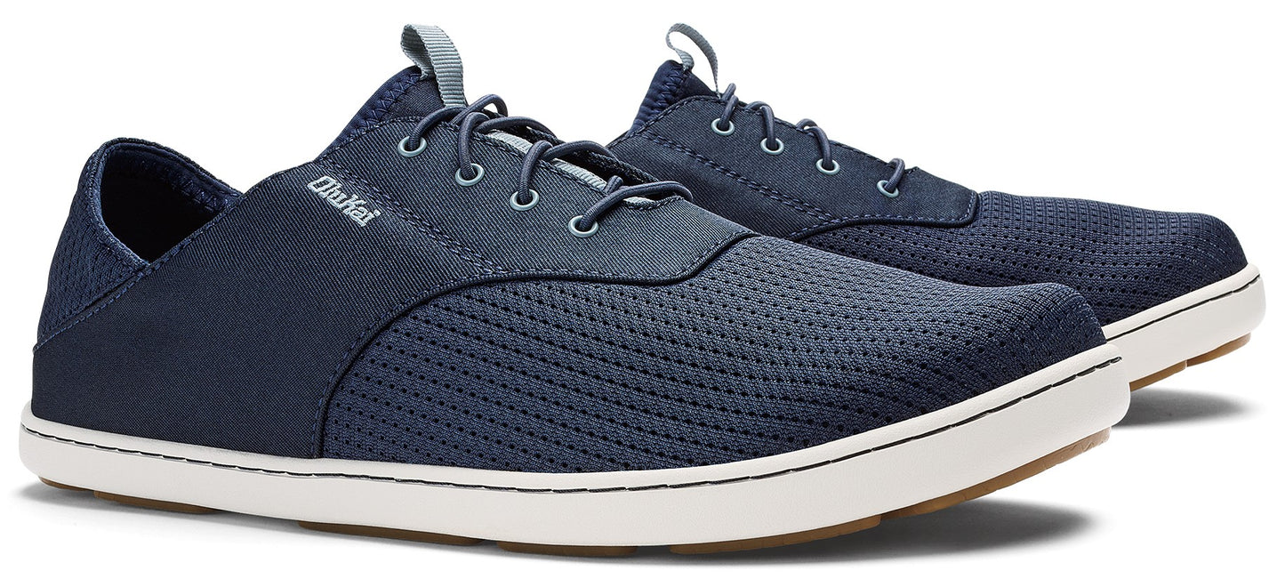Pair of low-profile, navy blue shoes with white soles and laces.