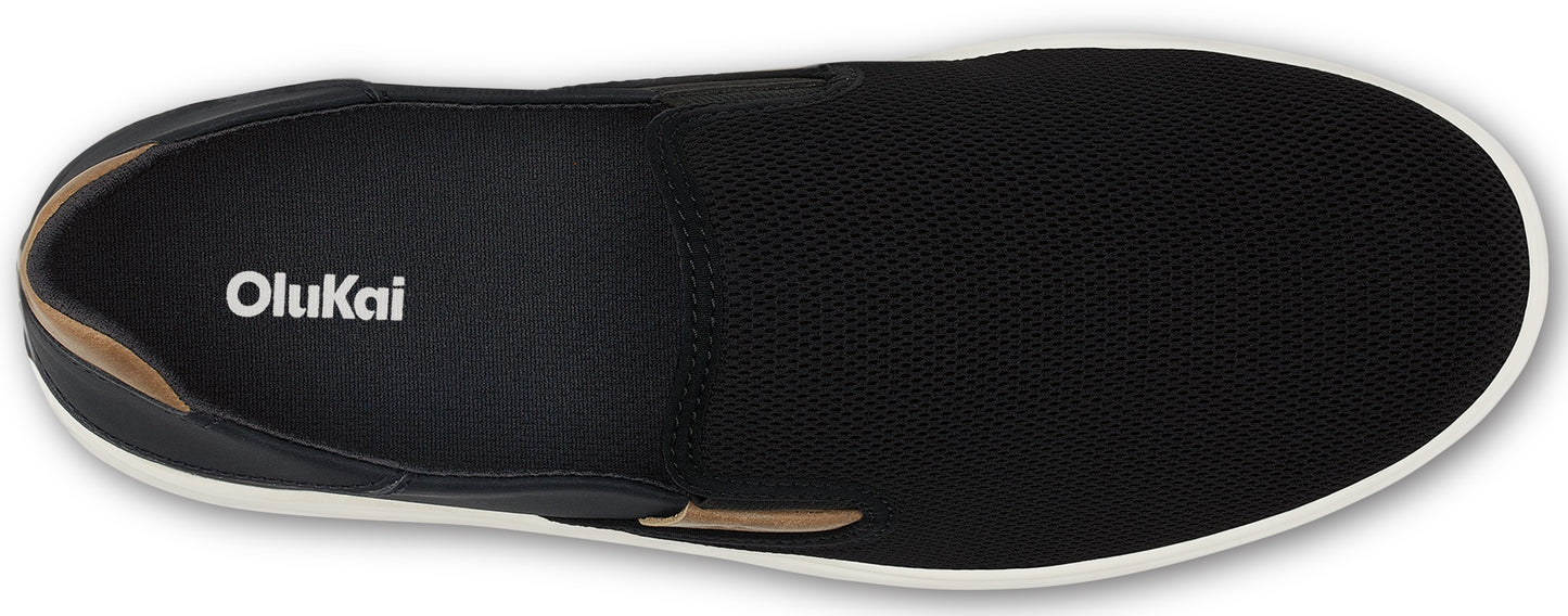 A black slip-on shoe with a white sole and the word Olukai printed on the insole.