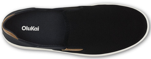 A black slip-on shoe with a white sole and the word Olukai printed on the insole.