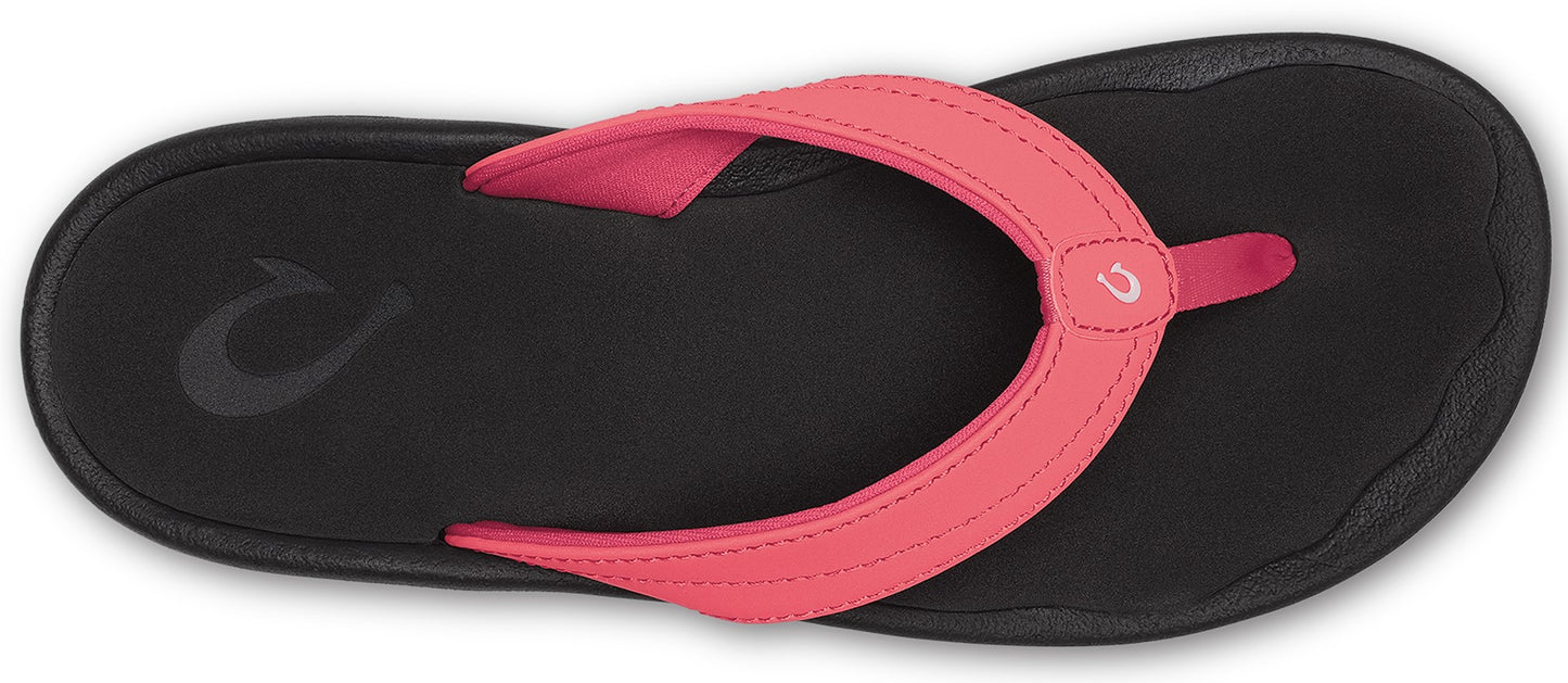 A pink strap sandal with a black sole.