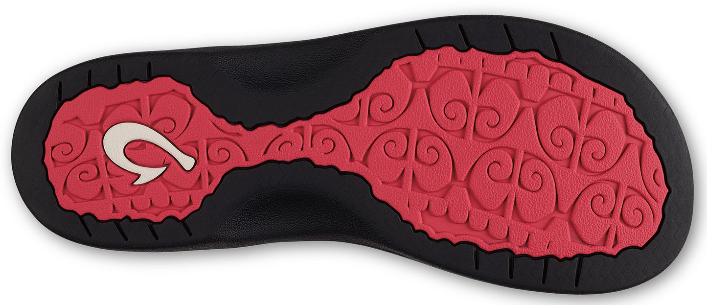 Bottom view of a sandal with red textured footbed and a hook design.