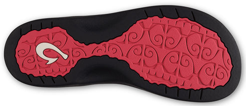 Bottom view of a sandal with red textured footbed and a hook design.