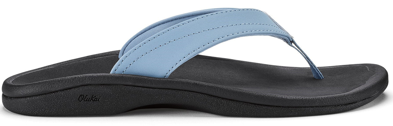 A light blue sandal with a black sole.