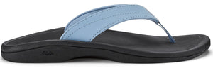 A light blue sandal with a black sole.