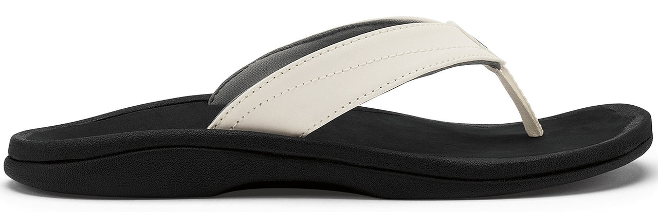 A black sandal with a white strap.