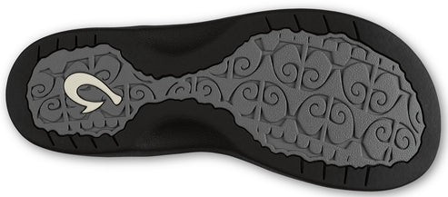 Bottom view of a black sandal with a light gray patterned sole and a white hook logo near the heel.