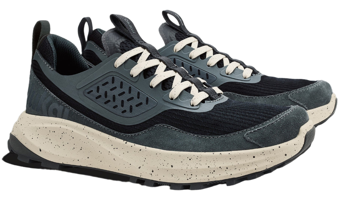 Pair of low-top hiking shoes with black mesh and dark gray suede upper, off-white laces, and thick speckled off-white midsole.