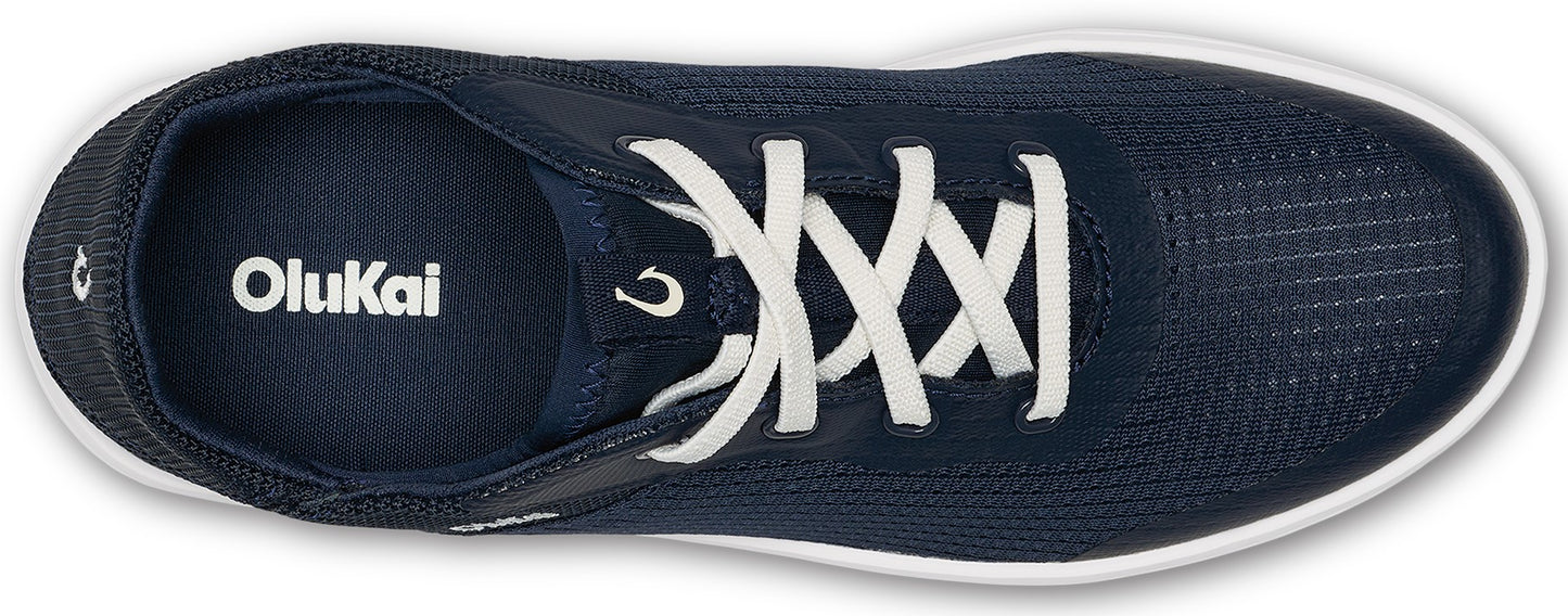 Navy sneakers with white laces and white soles, the text "OluKai" is printed on the insole.