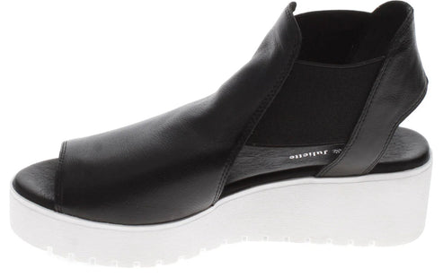 Black leather platform peep toe shoe with white sole.