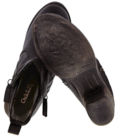 Pair of black ankle boots showing interior and soles.