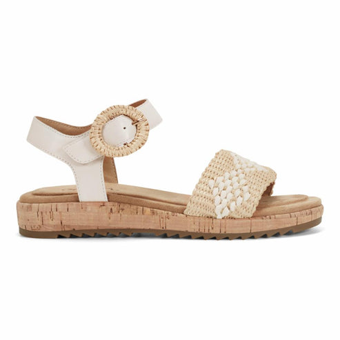 Off-white sandal with cork sole and raffia weave detail.