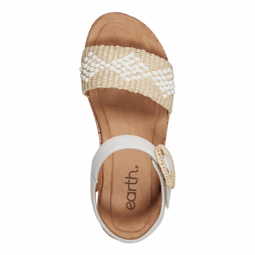 Overhead view of a sandal with a thick woven beige and white beaded strap and a white ankle strap with an earth. branded buckle.