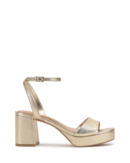 Gold platform sandal with block heel and ankle strap.