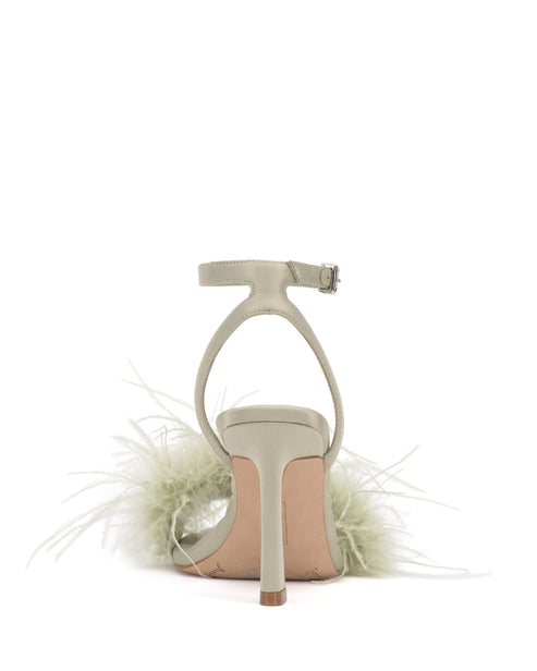 Back view of a stiletto heel sandal featuring an ankle strap and toe strap with attached green feathers.