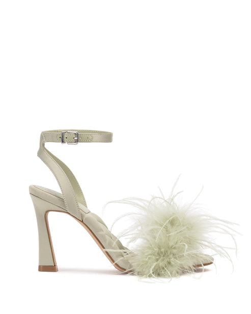 Sage green heeled sandal with ankle strap and toe feather embellishment.