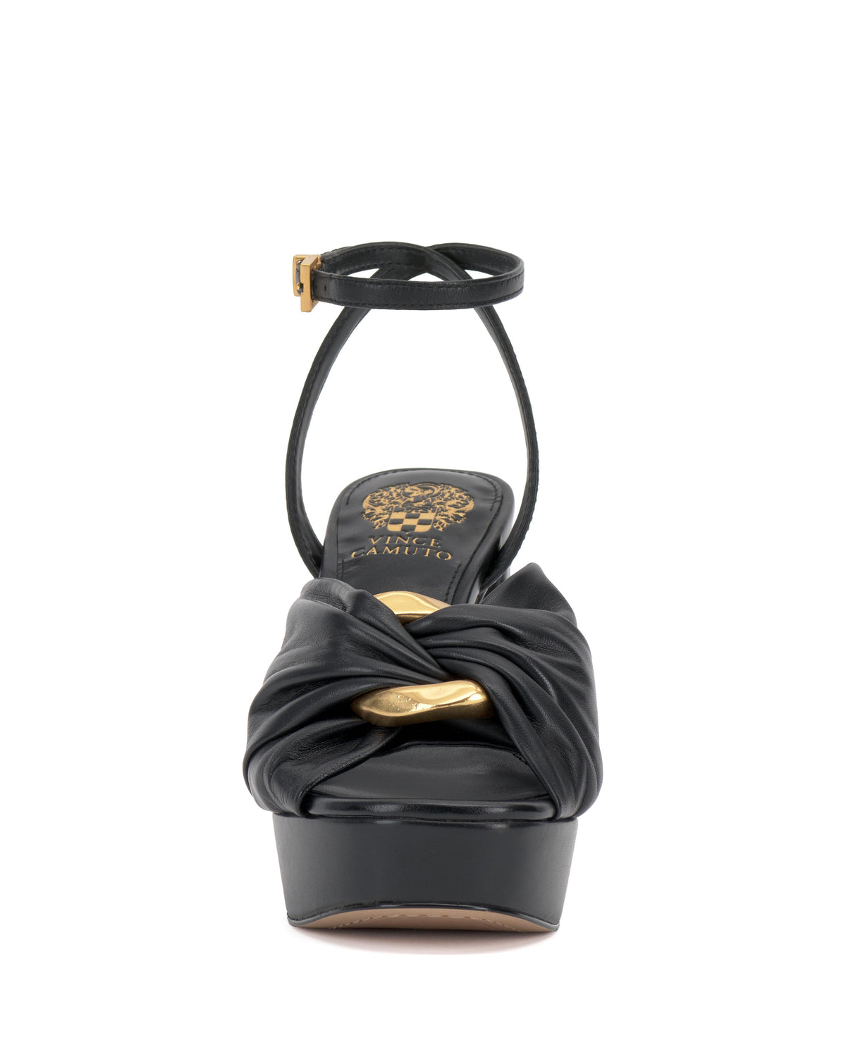Front view of a black platform sandal with an ankle strap and a gold decorative accent on the toe.