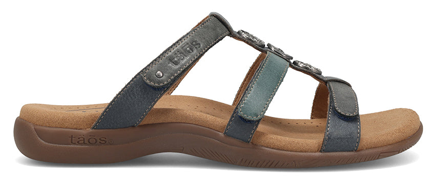 A three-strapped leather sandal with decorative embellishments.