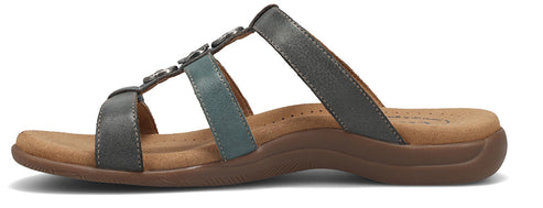 A sandal with gray straps.