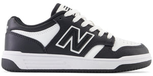 A black and white sneaker with a large letter N on the side and white laces.