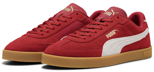 Pair of red low-top sneakers with white stripes and a gum sole.