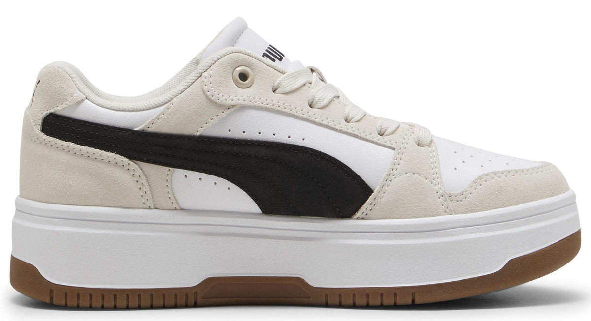 Low-top sneaker with a black stripe on a white and beige upper and white platform sole with brown accent.