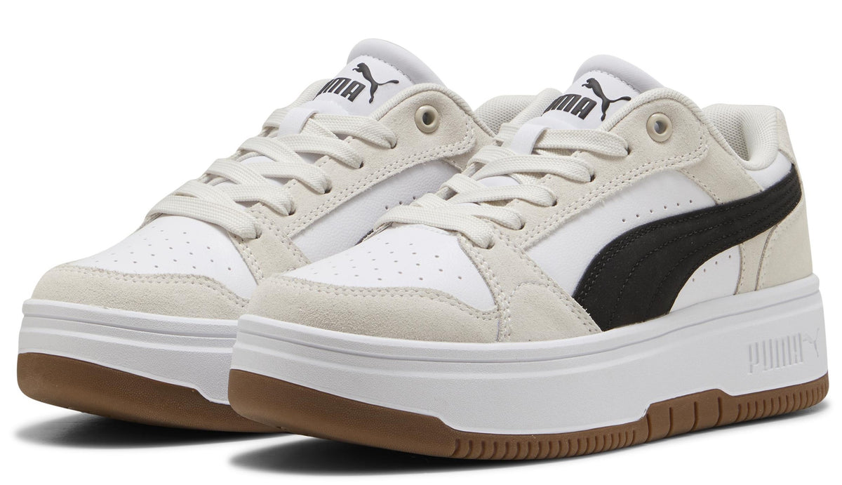 A pair of low-top sneakers with a white and beige upper, black stripe detail, white laces, and a thick white and brown sole.