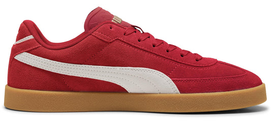 A red suede sneaker with a white side stripe and a tan rubber sole.