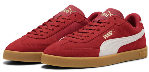 A pair of red sneakers with a white stripe and a tan sole.