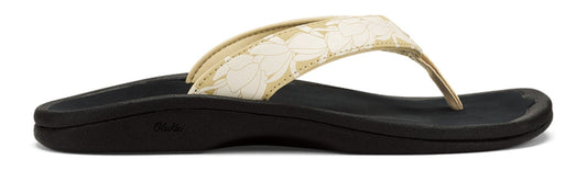 A sandal with a floral strap and a black sole.