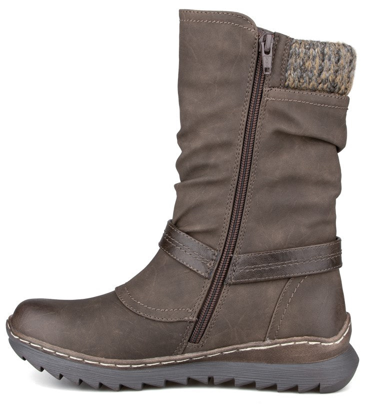 A brown mid-calf boot featuring a slouchy upper, a side zipper, a horizontal strap detail across the ankle, a sweater-knit collar, and a textured rubber sole with visible white stitching along the welt.
