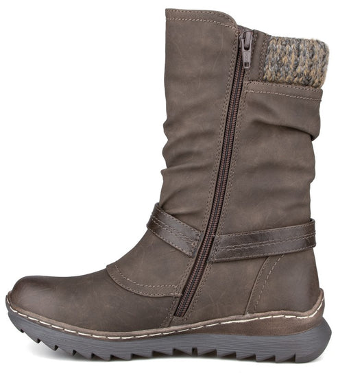 A brown mid-calf boot featuring a slouchy upper, a side zipper, a horizontal strap detail across the ankle, a sweater-knit collar, and a textured rubber sole with visible white stitching along the welt.