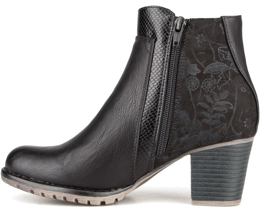 A black ankle boot with a block heel, featuring a smooth leather-like front, a snake-skin texture panel along the zipper, and a floral embossed suede-like panel on the heel, finished with a light-colored, ridged rubber sole.