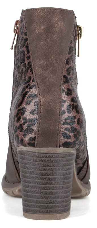 A back view of a grey and brown ankle boot with a leopard print pattern on the upper, featuring a stacked heel and a metallic side zipper.